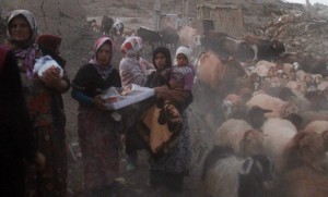 An earthquake victim carries clothing and other items in the earthquake-stricken town of Azerbaijan in Iran