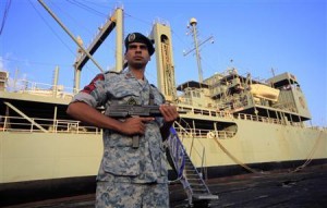 An Iranian soldier stands guard near Iranian Navy helicopter carrier Kharg at Port Sudan at the Red Sea State