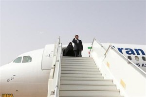 Iranian President Mahmoud Ahmadinejad waves as he arrives at Niamey airport