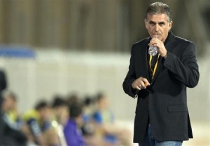 De Queiroz, coach of Iran, watches his players during their Asian Cup 2015 qualifying soccer match in Kuwait City