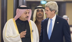 U.S. Secretary of State John Kerry speaks with Qatar's Foreign Minister Khalid al-Attiyah before the opening session of the Syrian Donors Conference at Bayan Palace in Kuwait City