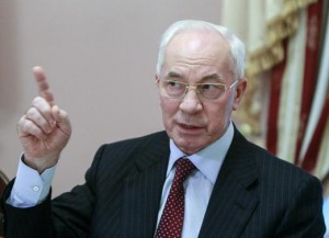 File photo of Ukraine's PM Azarov gesturing during a meeting with foreign journalists in Kiev