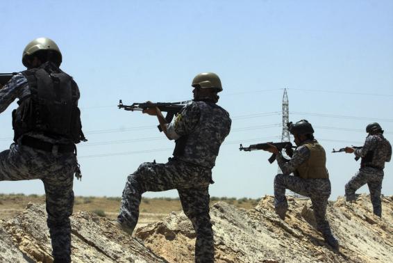 Members of the Iraqi security forces patrol an area near the borders between Karbala Province and Anbar Province