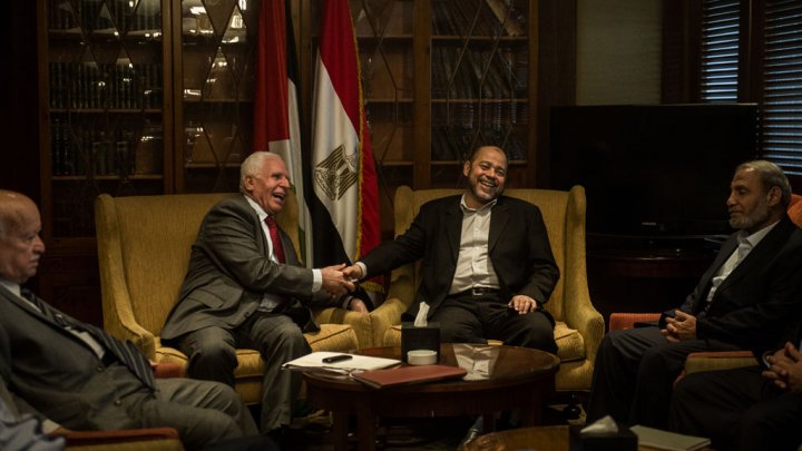 Fatah and Hamas representatives shake hands in Egypt's capital Cairo