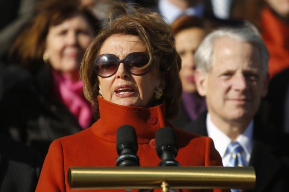 Pelosi, standing with fellow House Democrats, delivers remarks on immigration legislation on the steps of the U.S. Capitol in Washington
