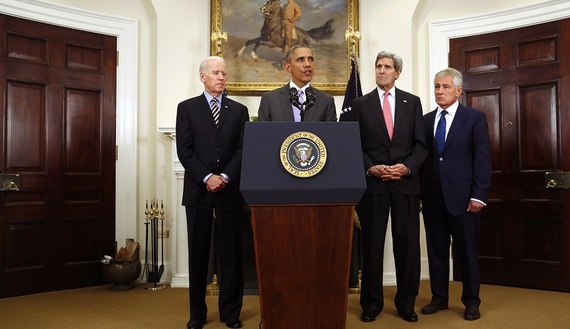 U.S. President Barack Obama is flanked by Vice President Joe Biden (L), Secretary of State John Kerry (2nd R) and Defense Secretary Chuck Hagel (R) as he delivers a statement on legislation sent to Congress to authorize the use of military force against the Islamic State. REUTERS/Jonathan Ernst.