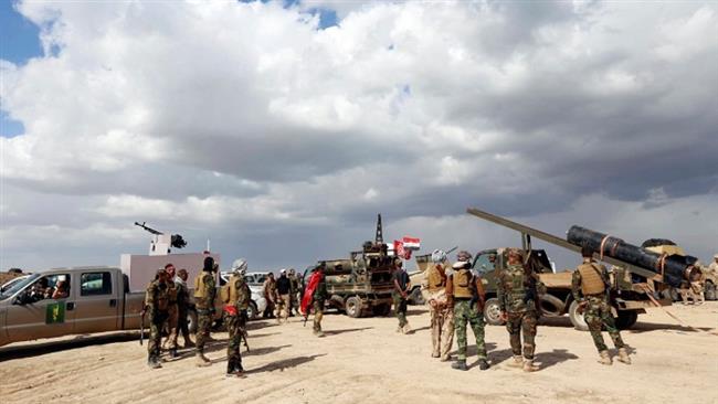Iraqi security forces and Shia fighters are seen during clashes with ISIL militants in Salahuddin province, March 2, 2015.