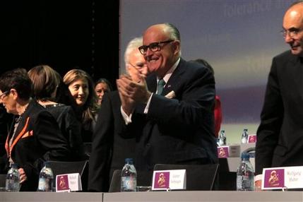 Former New York City Mayor Rudy Giuliani claps his hands at the start of a day-long conference on human rights organized by the Iranian exile opposition group National Council of Resistance of Iran on Saturday, March 7, 2015. Giuliani was one of the main speakers. (AP Photo/Frank Jordans)