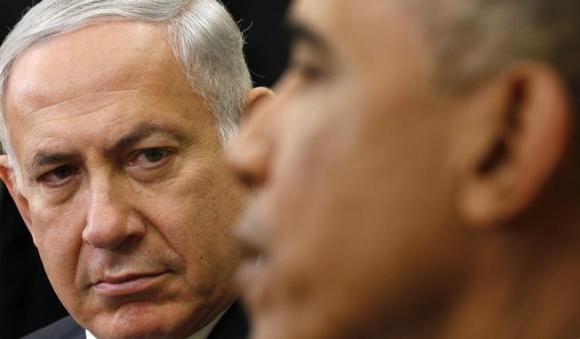Israel's Prime Minister Benjamin Netanyahu listens as U.S. President Barack Obama (R) speaks, during their meeting in the Oval Office of the White House in Washington October 1, 2014.